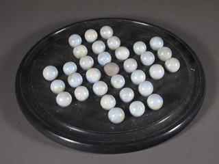 A circular slate solitaire board