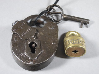 An iron heart shaped padlock and key marked Crown London,  together with a brass padlock marked 999