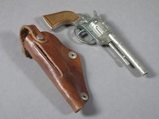 A Redondo miniature "Wild West" cap firing revolver marked  Mini Rayo complete with leather holster