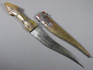 An Eastern dagger with 8" shaped blade contained in a brass scabbard with horn handle