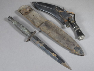A Fairburn Sykes style fighting dagger with 7" blade and  scabbard together with a Kukri with 7" blade and leather  scabbard