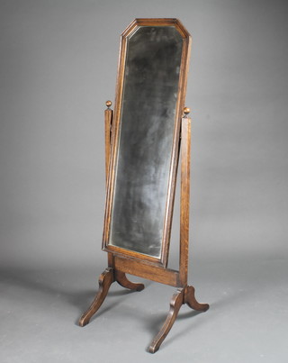A rectangular plate cheval mirror contained in a mahogany swing frame 17"w x 57"h