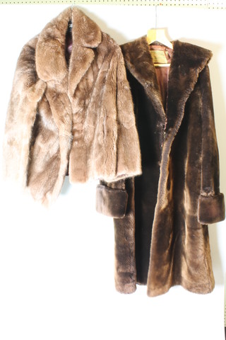 A lady's quarter length brown fur coat and a lady's full length simulated fur coat