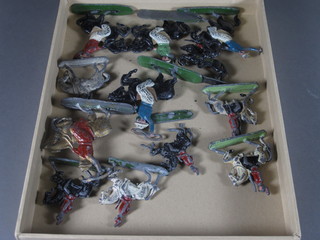 A collection of metal figures of cowboys etc