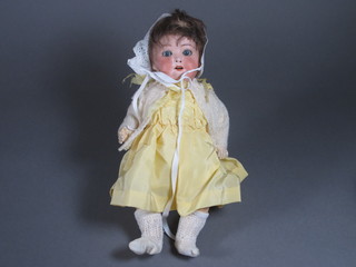 A German porcelain headed doll, head incised Heubach Koppelsdorf 320.7/0 Germany with open and shutting eyes and open mouth, 2 teeth with articulated body 12"