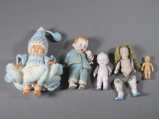 A collection of 5 miniature dolls