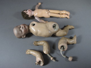A 19th Century porcelain headed doll, the head incised 46/0M  with open eyes, mouth with teeth and articulated limbs 11" and 1  other porcelain headed doll with articulated limbs, head incised  6, 12"