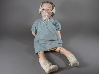 A porcelain headed doll by Simon & Halbig, head incised KR, with open and shutting eyes, open mouth and articulated body 24"
