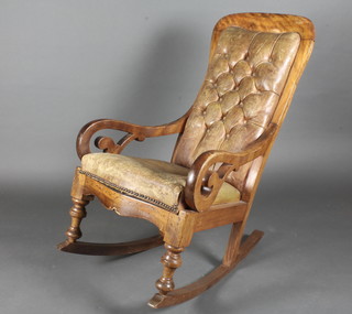 A Victorian mahogany show frame rocking chair upholstered in  green buttoned leather
