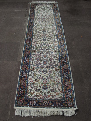 A white ground and floral patterned runner 128" x 30"