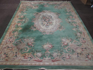 A green and floral patterned Chinese carpet 133" x 96"