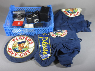 A sailor suit made from Players Navy cut card fabric comprising  hat, trousers and jacket an Olympus 35 camera, a Cornet camera  and a Brownie Junior box camera