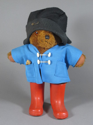 A Paddington Bear with blue jacket and red boots