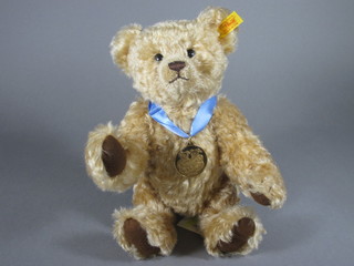 A 2002 Steiff teddybear with brown fur and articulated limbs and medallion dated 2002, 11"