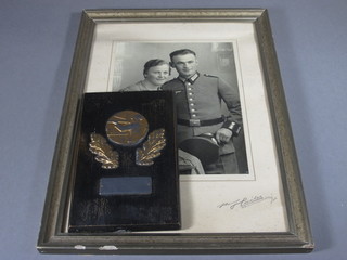 A German wooden and metal shooting wall plaque trophy dated 1938 8" and a photograph of the recipient 8 1/1" x 7"