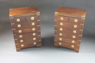 A pair of military style mahogany bedside chests fitted brushing  slides above 2 short and 5 long drawers with brass countersunk  handles 18"w x 11 1/2"d x 27" 1/2"h