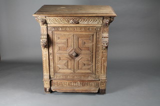 A Victorian carved oak cabinet fitted a drawer above a cupboard enclosed by a panelled door 35"w x 20"d x 41"h