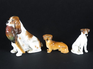 A Royal Doulton figure of a seated Dachshund 1", do. Jack  Russell and do. Spaniel with cock pheasant 4"