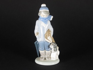 A Lladro figure of a standing boy with scarf and dog 8"