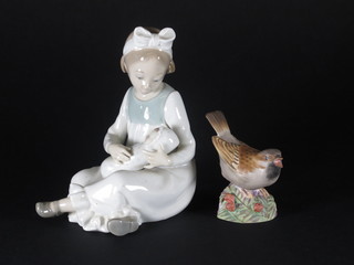 A Nao figure of a crouching girl with doll 6" and a Royal Worcester figure of a swallow