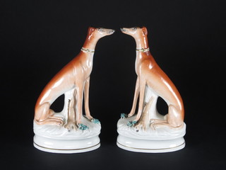 A pair of Staffordshire figures in the form of seated greyhounds  9"  ILLUSTRATED