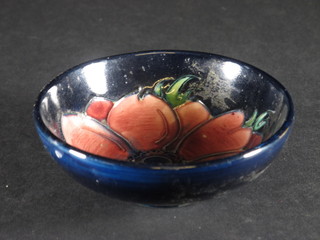 A circular Moorcroft blue glazed bowl decorated Anemones, the base impressed Moorcroft 4"  ILLUSTRATED