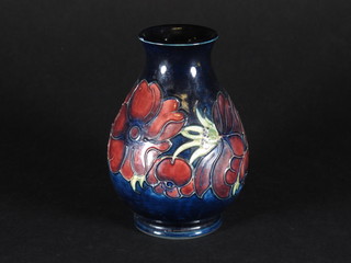 A Moorcroft blue glazed club shaped vase decorate Anemones 5"  ILLUSTRATED
