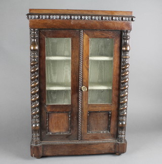 A Victorian Continental rosewood miniature display cabinet fitted shelves enclosed by a glazed panelled door and with spiral turned  columns to the side 60 1/2"w x 24"h x 8"d