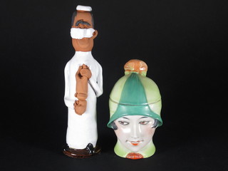 An Art Nouveau Continental porcelain jar and cover in the form  of a bonnetted lady 5", together with a Chelsea pottery figure of  a standing male midwife 8 1/2"