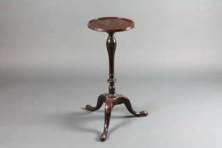 A circular 19th Century mahogany kettle stand raised on a tripod  base 12"w x 29"h