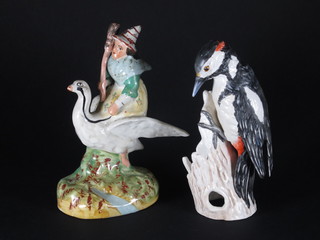 A curious Staffordshire figure of a witch flying a goose 7 1/2"  and a Goebel figure of a bird 7"