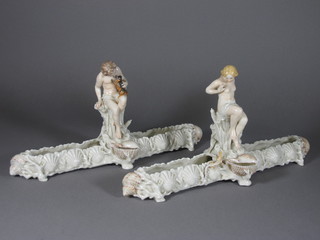 A pair of Victorian rectangular porcelain vases with shell decoration surmounted by a figure of a seated boy and girl 16"   ILLUSTRATED