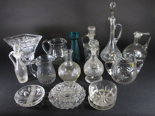 A diamond shaped cut glass vase 10", a twin handled bowl 5", a glass jug and a collection of decanters etc