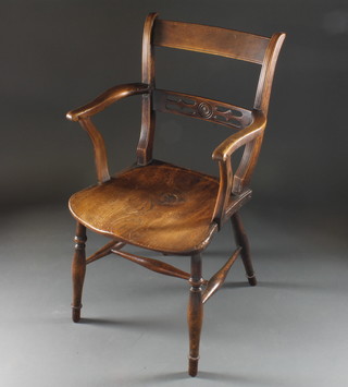 A 19th Century elm and bar back Windsor chair with pierced  mid rail, raised on turned supports with H framed stretcher