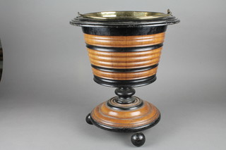 A turned circular Continental mahogany peat bucket with brass liner raised on bun feet 14" x 16"