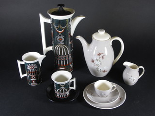 A 13 piece Port Meirion Magic City coffee service comprising coffee pot - crazing to handle, cream jug, 6 saucers - 1 chip to  rim and 5 cups - 4 cracked, together with a 20 piece Royal  Doulton Forest Pine pattern coffee service comprising coffee pot,  cream jug, 6 plates 6 1/2", 6 cups - 1 cracked and 6 saucers - 1  cracked