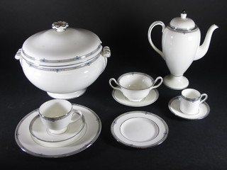A 93 piece Wedgwood Amherst pattern dinner/coffee service comprising soup tureen and cover 9", 2 twin vegetable tureens  and covers 8", 12 dinner plates 10 1/2" - some rubbing and  contact marks, 1 with chip to rim, 12 breakfast plates 9", 10 side  plates 8" - some rubbing, 3 pudding soup plates 9", 2 pudding  bowls 8", 4 tea plates 6", 6 twin handled soup bowls - 3 cracked,  12 saucers 6 1/2", 3 saucers 6", 4 cups, coffee pot - cracked and  chips, 9 coffee cans, 11 saucers 5"