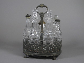 A 7 bottle glass cruet set contained in an oval pierced silver  plated frame, f,