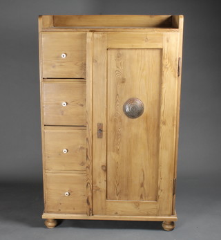 A stripped and polished pine combination wardrobe the top with three-quarter gallery, fitted 4 shelves and having a cupboard to  the side enclosed by a panelled door 33 1/2" x 54"h x 17"d