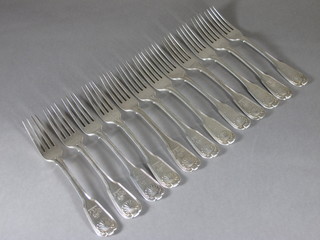A set of 12 George III silver fiddle, thread and shell pattern table forks with armorial, London 1811, 35 ozs