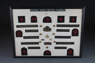 A display of various Royal Naval cap tallies and badges with  cloth insignia