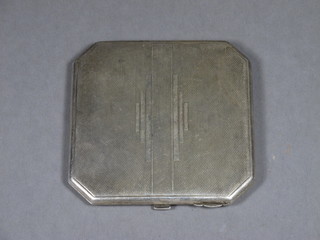 An Art Deco silver compact with engine turned decoration, Birmingham 1934