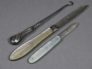 A Victorian silver bladed folding fruit knife with mother of pearl  grip Sheffield 1847, 1 other and a button hook
