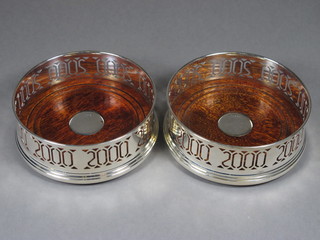 A pair of pierced silver wine bottle coasters with Millennium hallmark, boxed