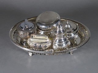 A circular silver plated tobacco box with hinged lid, a silver  plated 3 piece condiment set, 2 silver plated table lighters and a  basket
