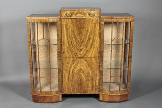 An Art Deco figured walnut display cabinet, the centre section fitted a drawer above a cupboard, flanked by a pair of cupboards  enclosed by astragal glazed panelled doors 48"w x 13"d x 45"h