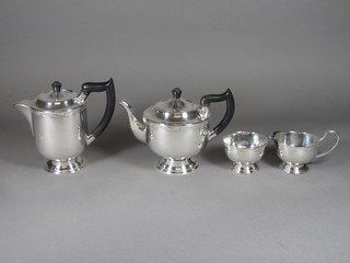 A silver plated 4 piece tea service comprising teapot, sugar bowl, milk jug and hotwater jug