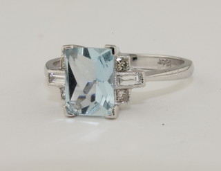 A lady's 18ct white gold dress ring set a rectangular cut aquamarine surrounded by diamonds