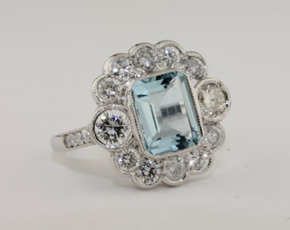 A lady's 18ct white gold dress ring set a rectangular cut aquamarine surrounded by diamonds, approx 1.50ct/1.15ct