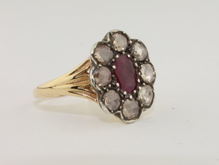 A lady's 18ct yellow gold dress ring set an oval cut ruby surrounded by diamonds